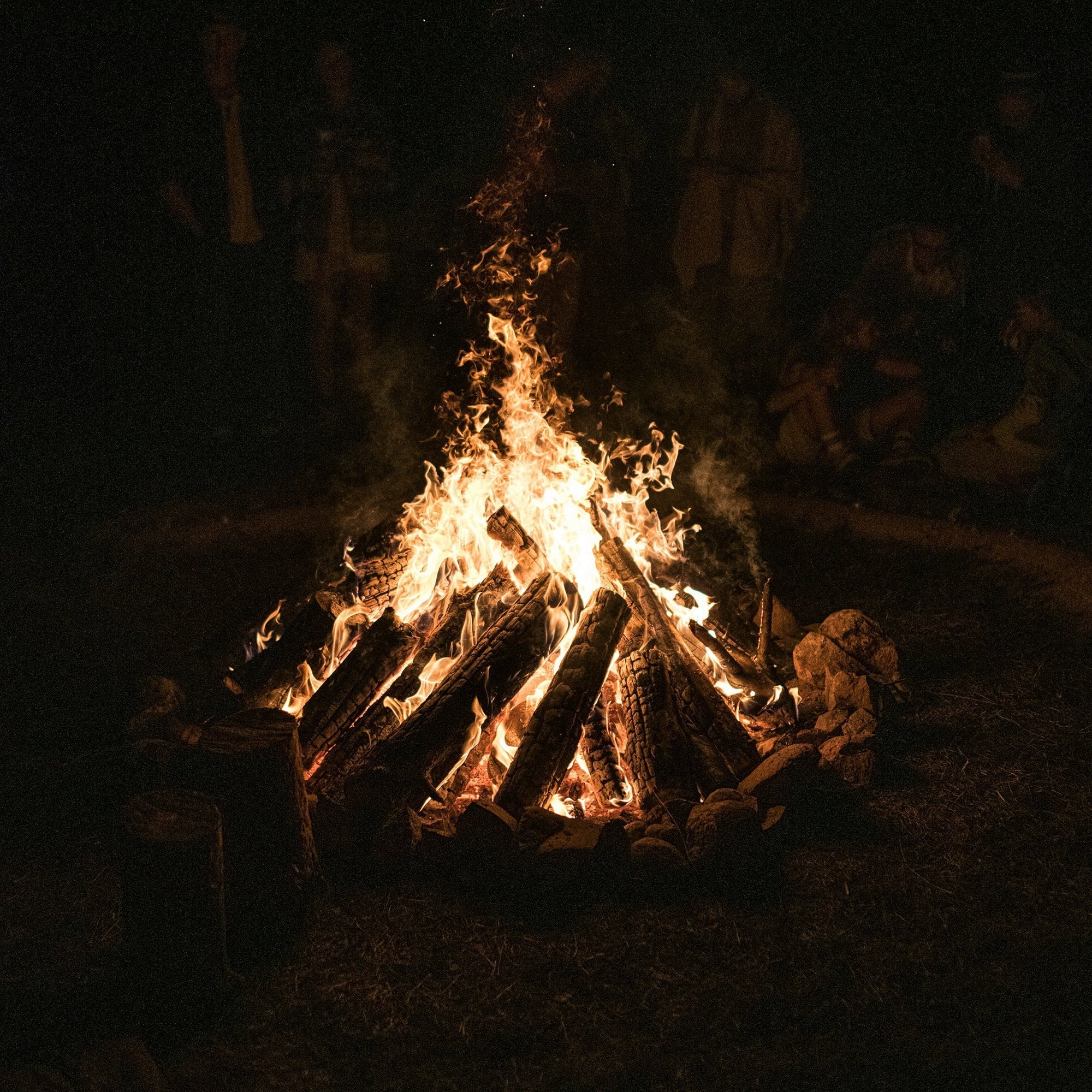 Soulful Sunday campfire scene with people gathered under the Western sky