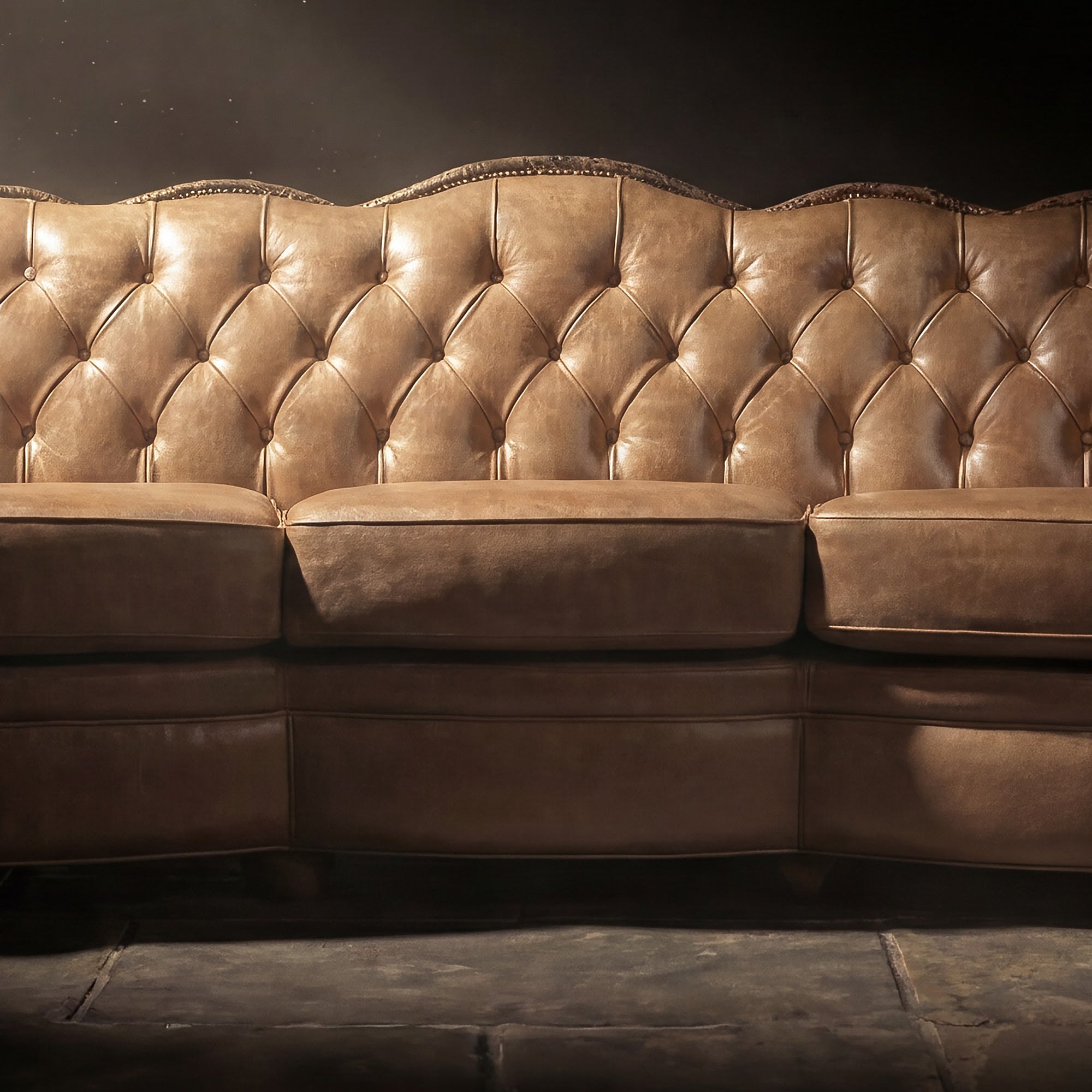 Close-up of a western leather sofa with natural patina, and soft lighting.