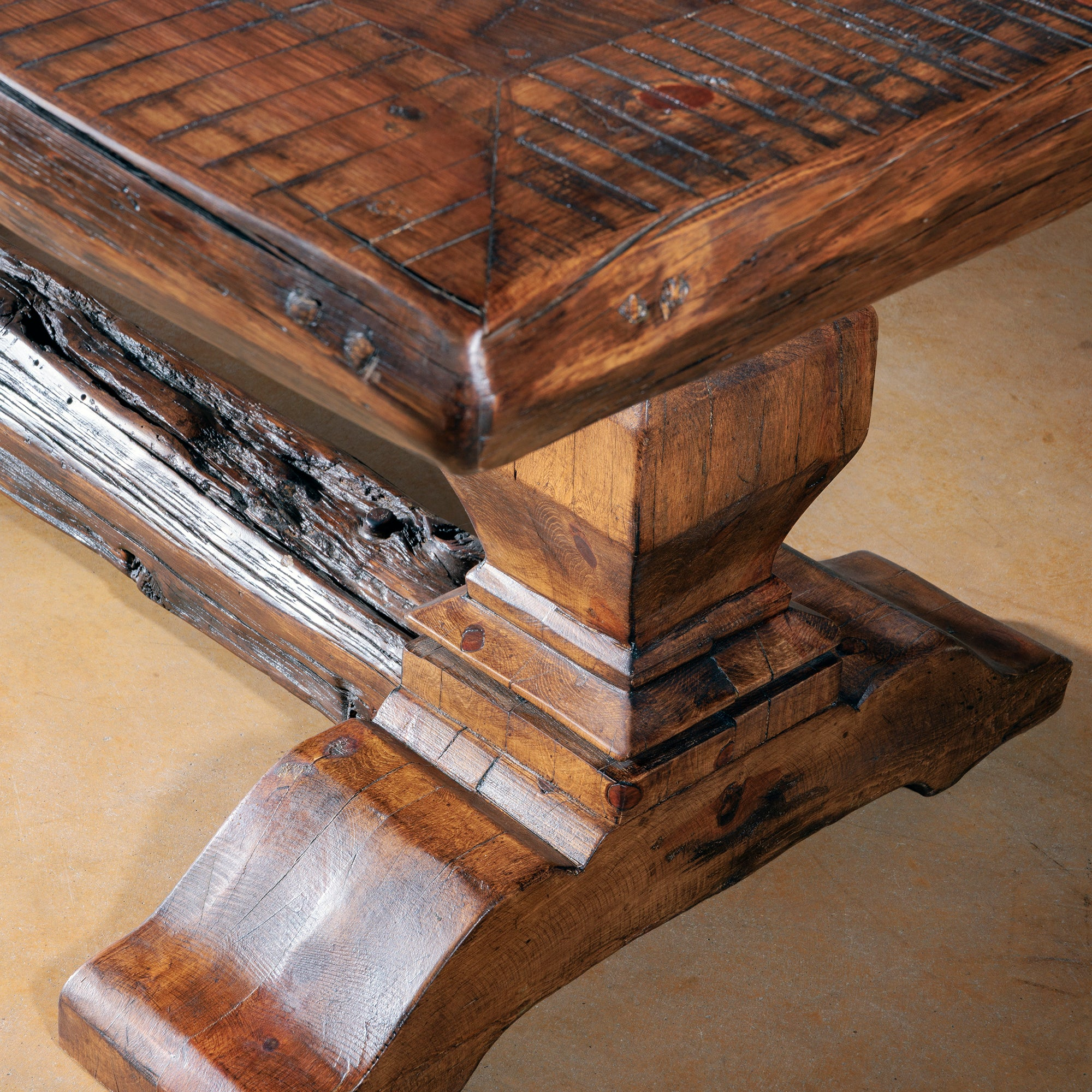 Handcrafted Western dining table in solid hardwood with forged-iron base and rustic reclaimed wood top.