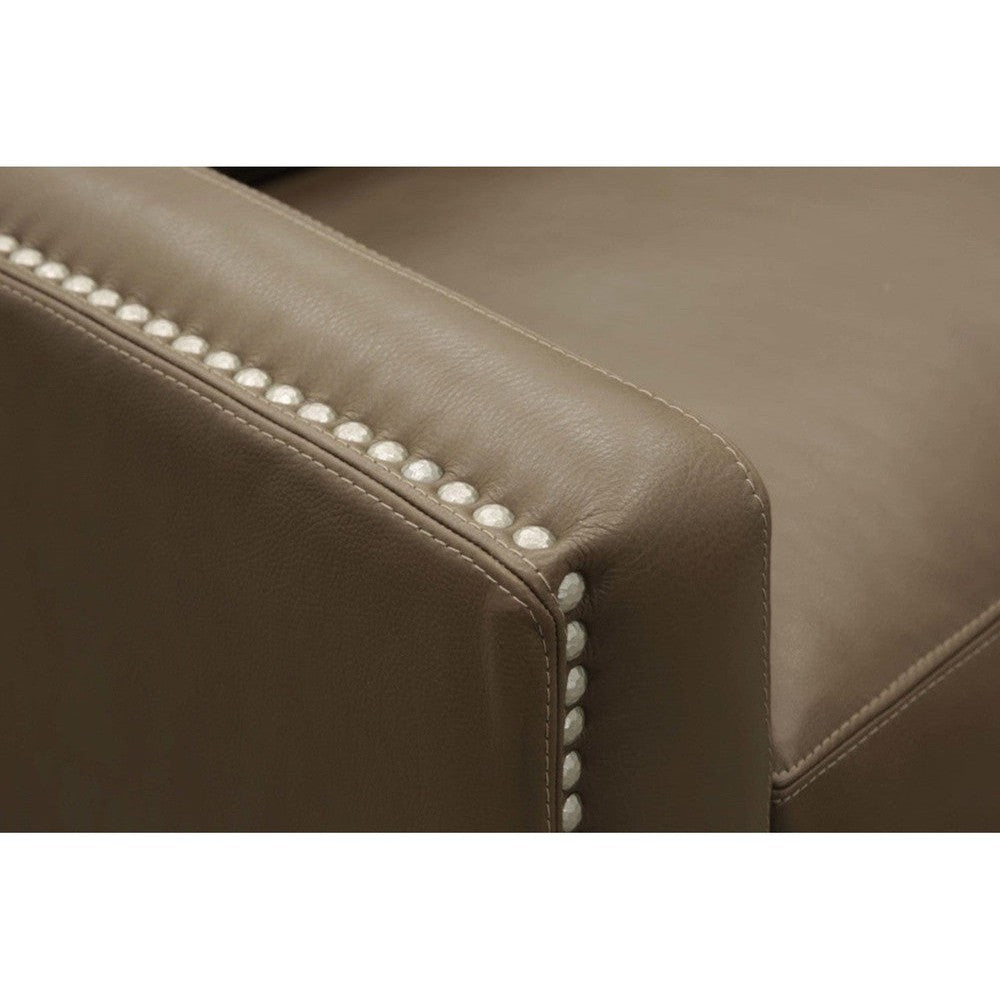 Close-up of nailhead trim on the brown leather armrest
