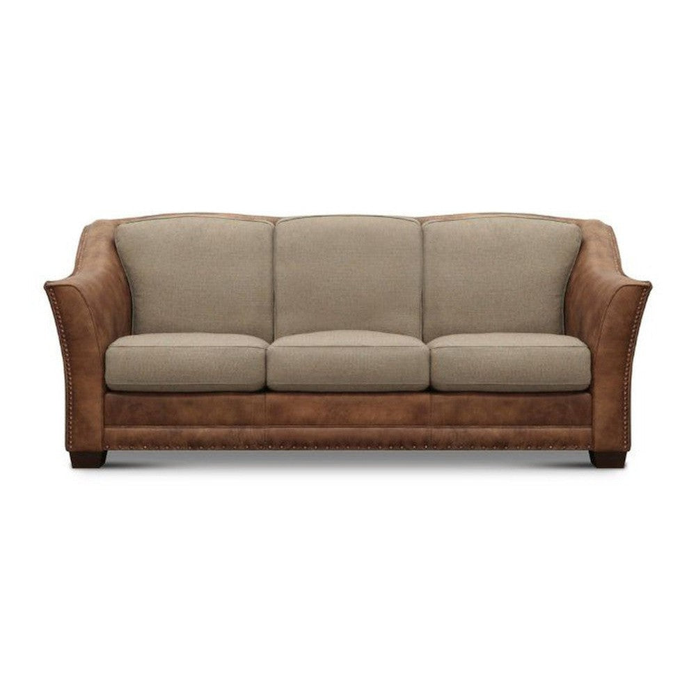 Two-tone sofa with beige cushions and brown leather accents