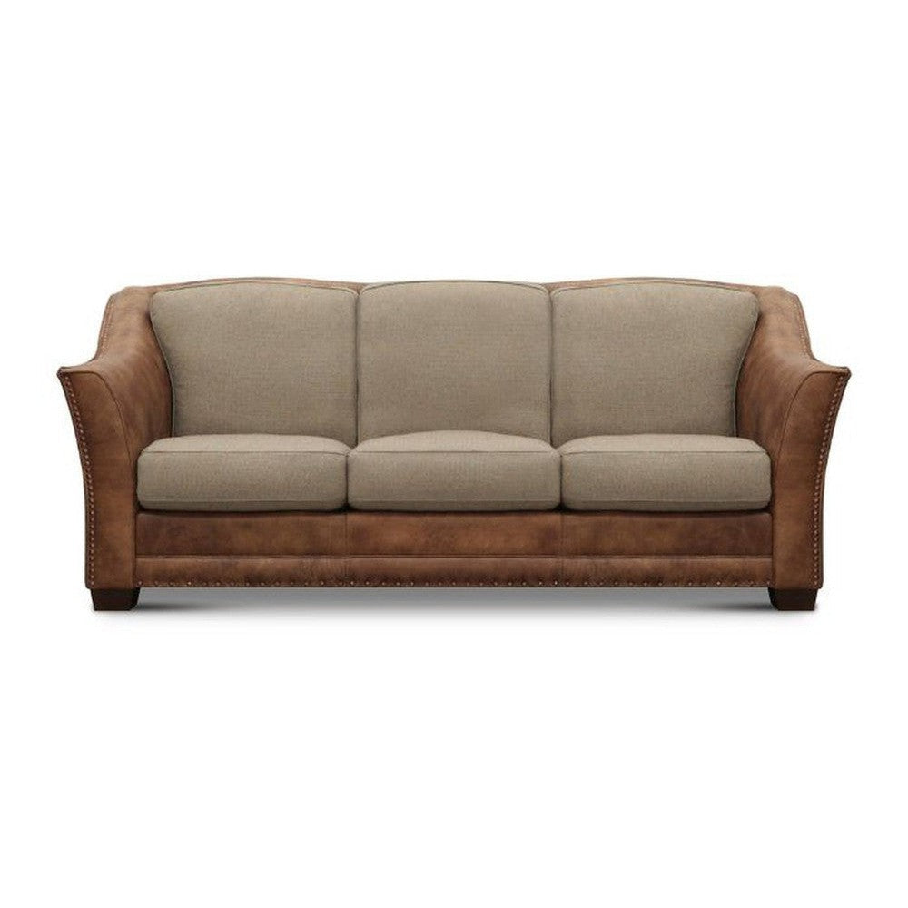 Experience the best in rustic elegance with the Arizona Sofa. Crafted with top grain leather and high-quality upholstery, this piece of furniture is designed to offer the perfect balance of comfort and charm. With its unique turquoise and rust coloring, this eye-catching sofa is sure to be a conversation starter for any room.     Leather: Legends Moccasin-020  Fabric: Malibu Canyon Prism  Nailhead: #1  Legs: Nutmeg
