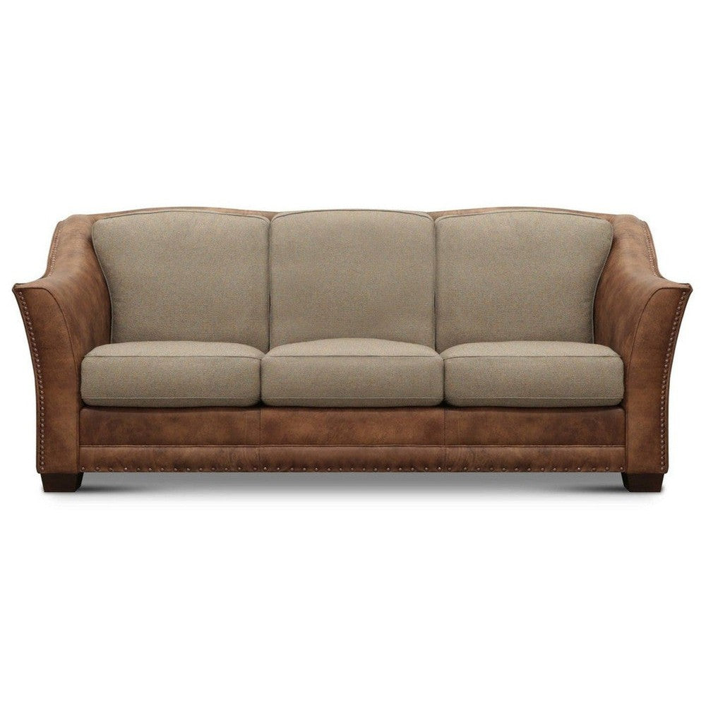 Two-tone sofa with beige cushions and brown leather accents