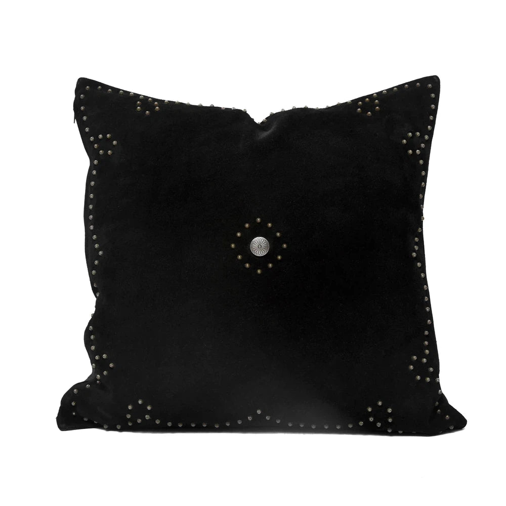 Classically crafted in suede, this Western Concho Pillow is perfect for any living space. Boasting a single silver concho center and a silver-studded border, its rustic elegance is available in four versatile shades: black, gray, navy, and tobacco. Add a luxurious touch to your the home with this timeless option.