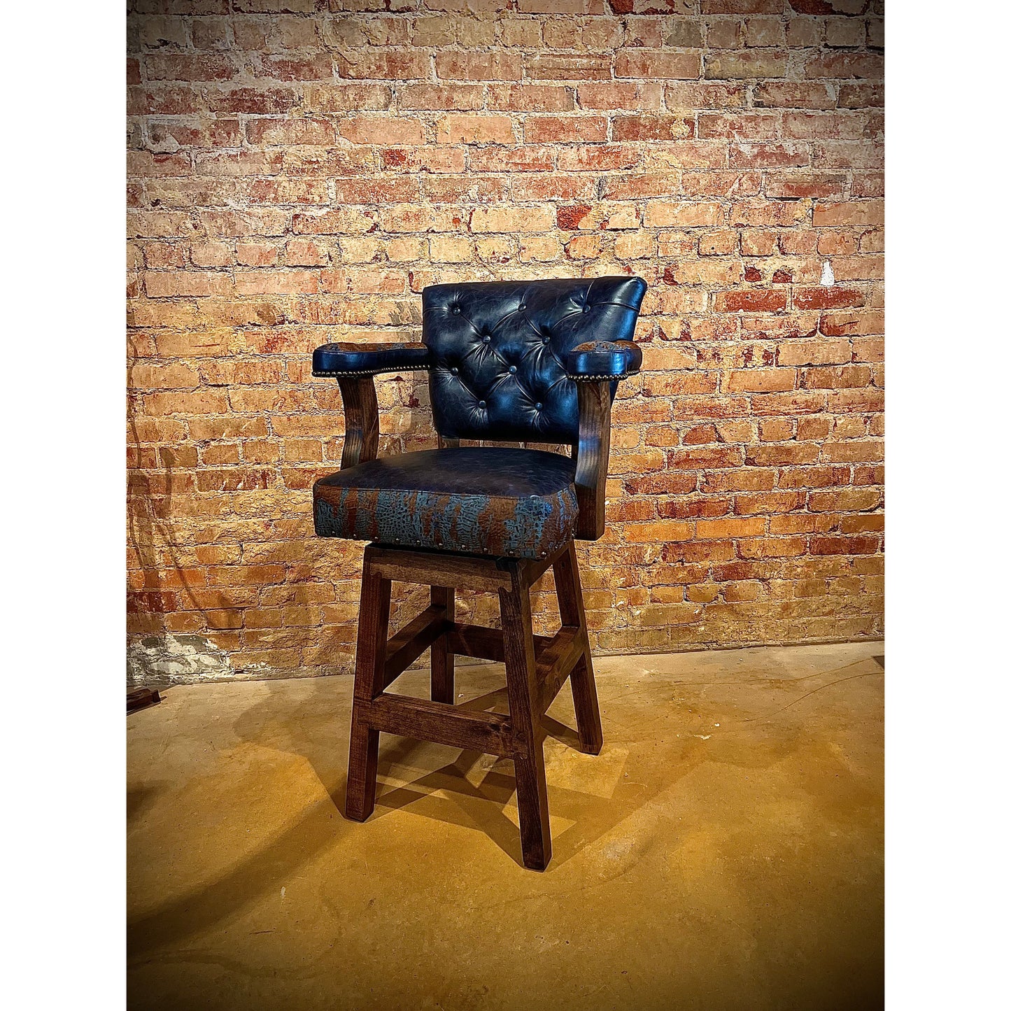 Add a touch of western flair to any room with the Blue Acid Croc Chisum Barstool. The acid wash croc accent cowhide and navy leather provide a unique and stylish look. With its comfortable design, this barstool is perfect for lounging or entertaining.