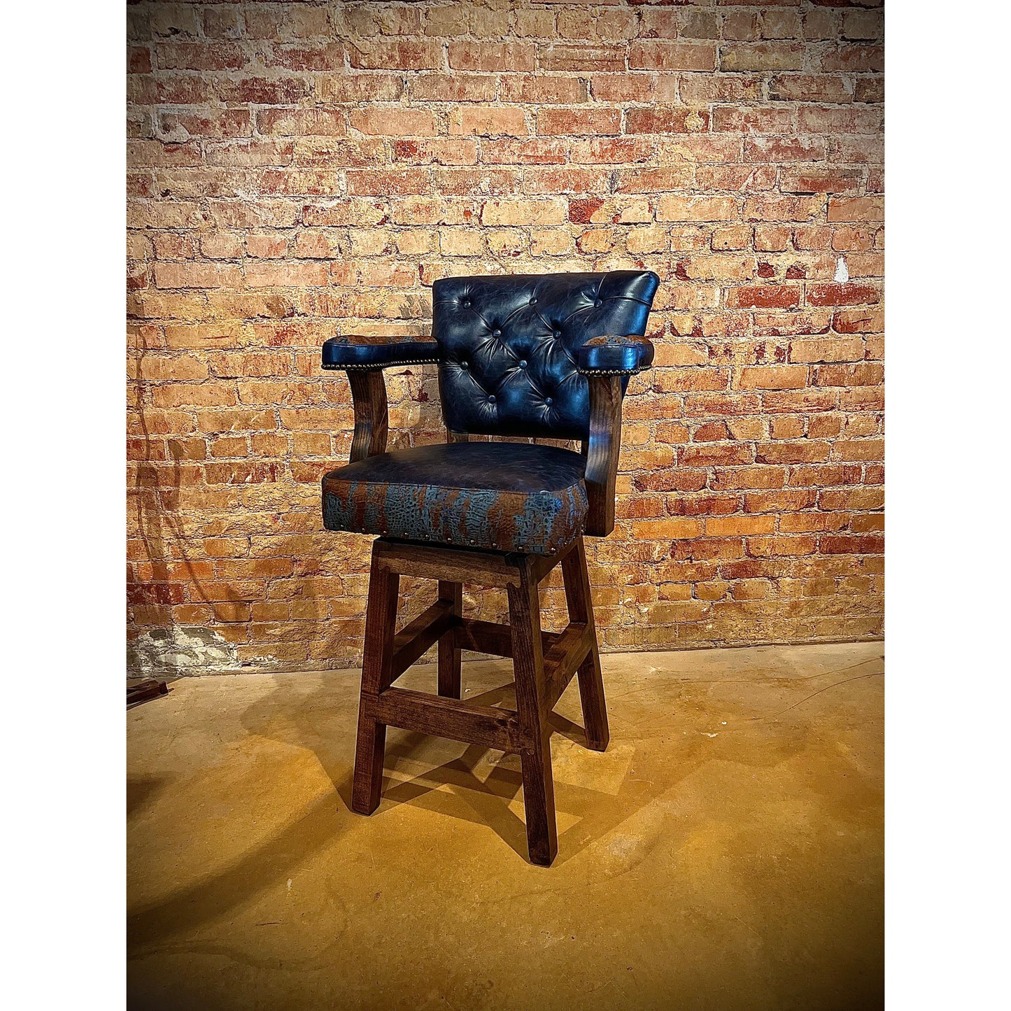 Add a touch of western flair to any room with the Blue Acid Croc Chisum Barstool. The acid wash croc accent cowhide and navy leather provide a unique and stylish look. With its comfortable design, this barstool is perfect for lounging or entertaining.