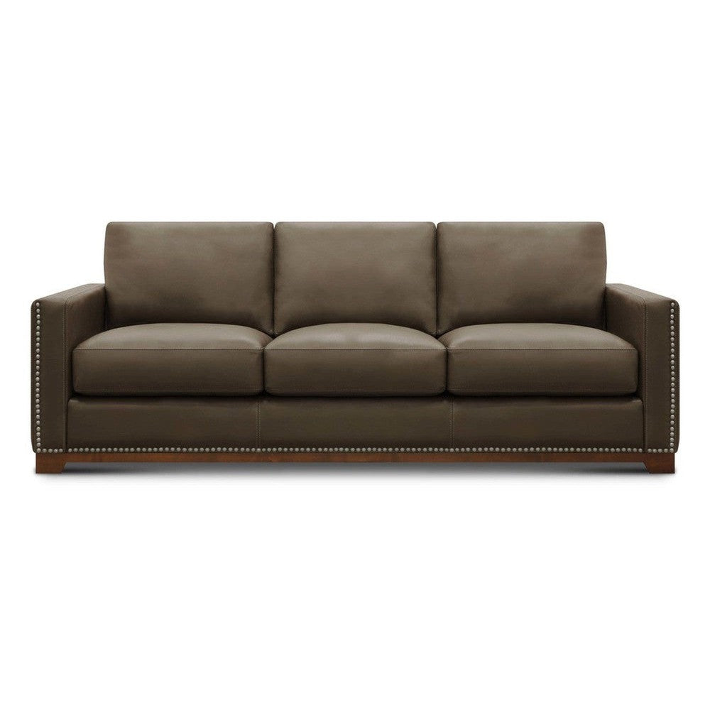 Brown leather sofa with nailhead trim and straight arms