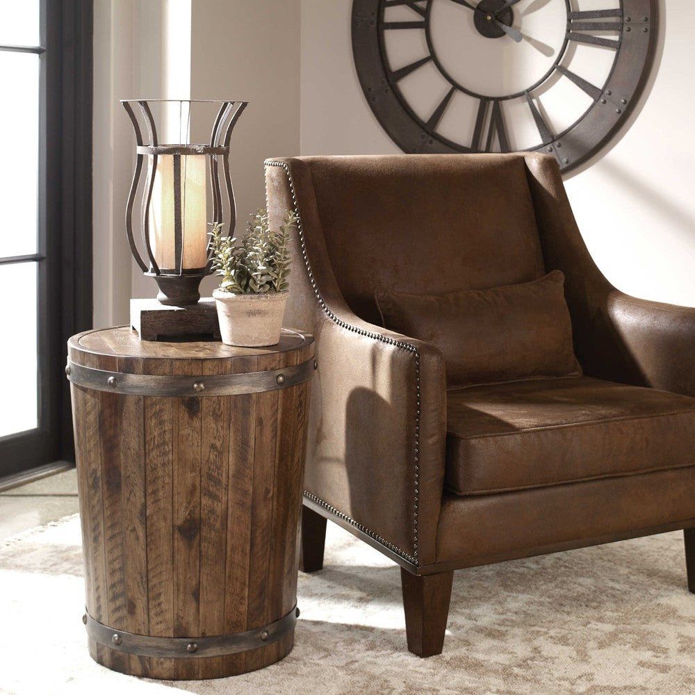 The Ceylon Side Table epitomizes rustic charm. It is constructed with solid distressed acacia wood and finished in a weathered walnut stain, reinforced with sheet metal strapping and burnished brushed steel rivets. This timeless piece is perfect for adding a touch of style and character to any living space.