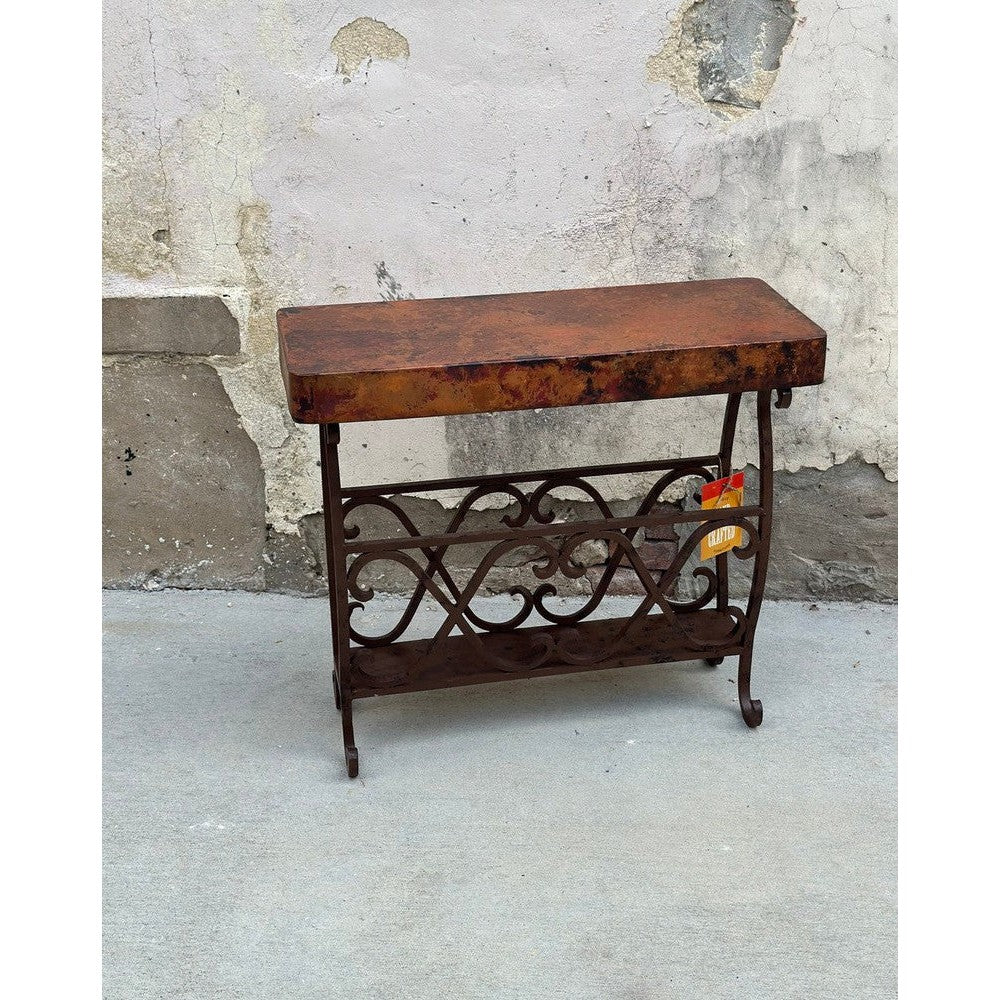 Experience the unique combination of industrial and rustic style with the Copper Magazine Table. Crafted from hand-forged iron and hammered copper, this side table is sure to add a modern, functional touch to any room. Its ample surface space provides the perfect place for your favorite magazine or book.