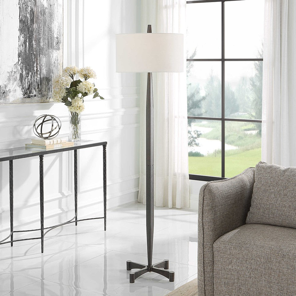 This classic metalwork inspired table lamp is perfect for any industrial decor. Constructed with a tapered base and aged black finish, its subtle rust distressing adds an authentic vintage touch. Enjoy the perfect ambiance when you turn on the Counteract Table Lamp.