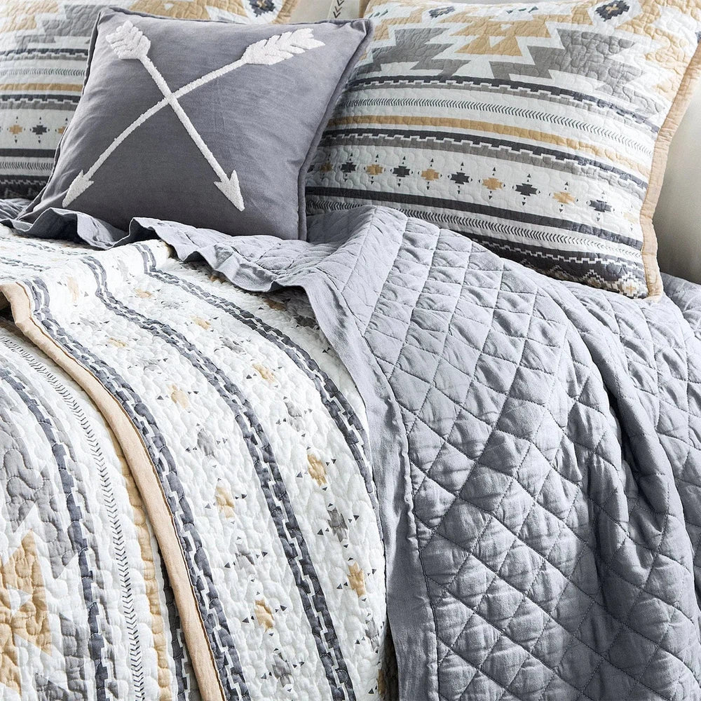 Bring a subtle Southwestern style to your bedroom with the Desert Sage Quilt Set. Its modern Aztec-style kilim pattern is complemented by a tan flange border and stipple quilting. The collection also features a coordinating canister set, and can be further enhanced by adding our linen cotton diamond quilt, velvet, woven leather, and washed linen pillows and shams.