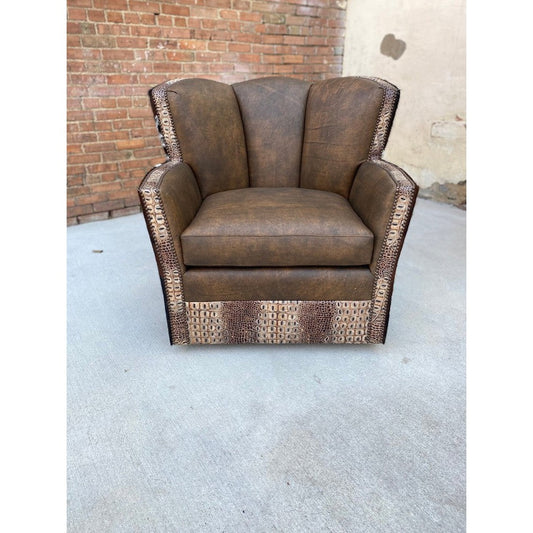 The Dillon Conch Chair is the perfect combination of luxury and practicality. Crafted with top grain leather and stamped gator trim, this chair swivels for easy movement and is complete with tri-colored cowhide for a touch of added comfort and style. Generous proportions and a classic cowboy design make this chair big on comfort and impact.