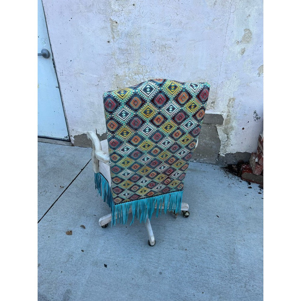 The Dowdy Office Chair gives you both comfort and style. It's upholstered with top grain leather, with an embossed aztec accent and fringe around the seat. This office chair is mounted on casters, so it's easy to move around, and the bright pop of color gives it a fashionable touch.