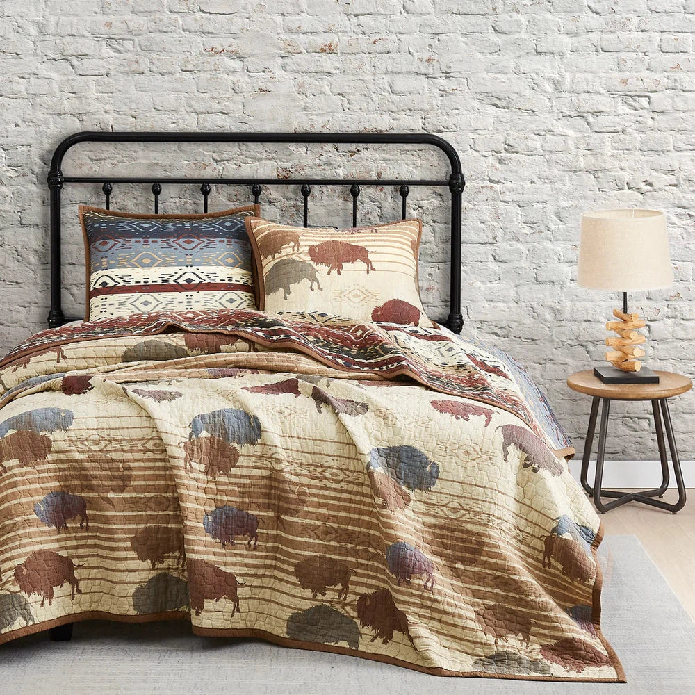 Featuring bold colors that capture the wild spirit of the American West, our Home On The Range Quilt Set is a striking homage to the iconic buffalo. Crafted with Aztec patterned fabric and a geometric ombre reverse, this quilt boasts alternating stripes and tribal motifs for an eye-catching look.