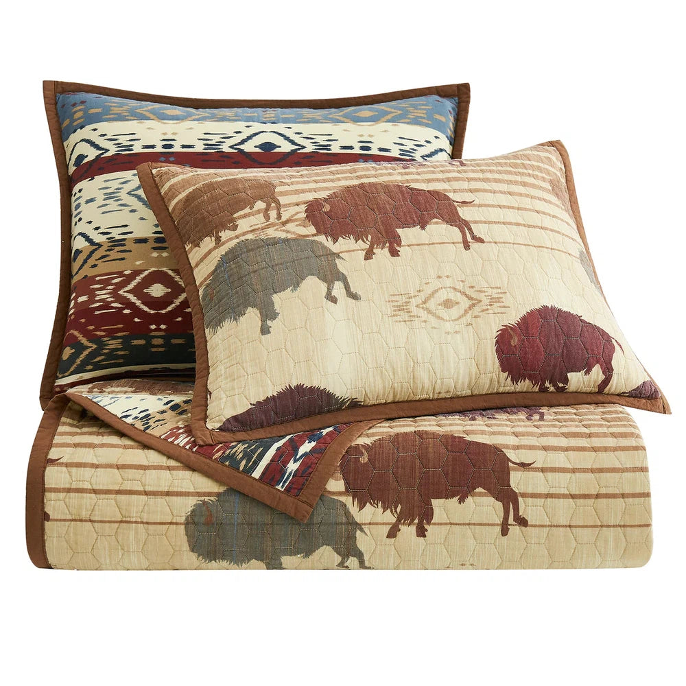 Featuring bold colors that capture the wild spirit of the American West, our Home On The Range Quilt Set is a striking homage to the iconic buffalo. Crafted with Aztec patterned fabric and a geometric ombre reverse, this quilt boasts alternating stripes and tribal motifs for an eye-catching look.