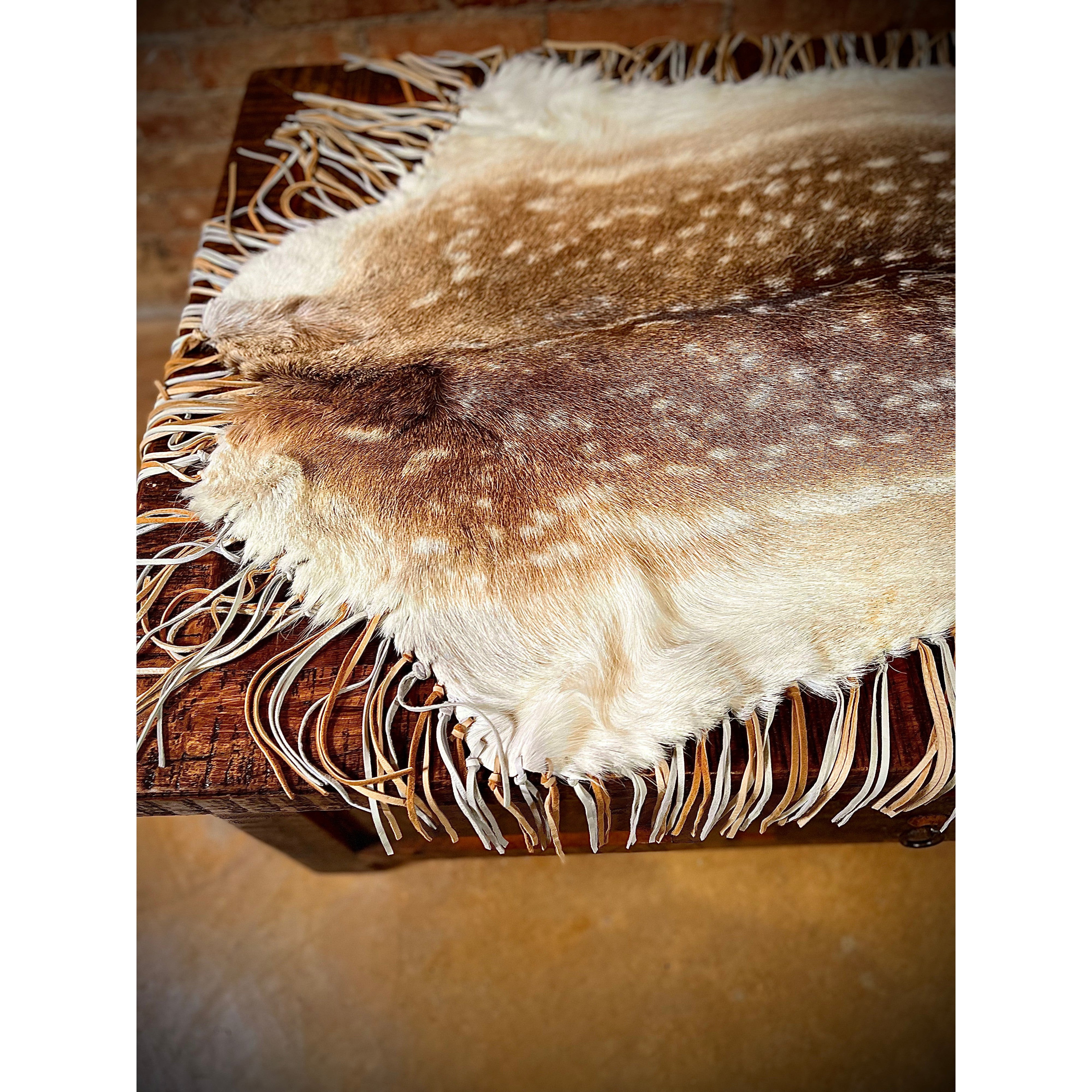 Enhance the aesthetic of your coffee table or dining table with our premium Fallow Deer Hide Table Topper. Made from luxurious fallow deer hide, this topper features a stunning leather fringe detail for added elegance. Perfect for adding a touch of sophistication to any table setting. Ships within one week.