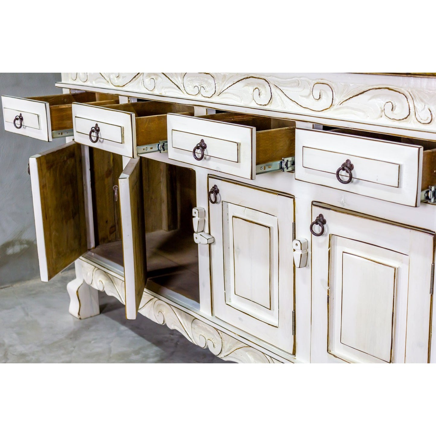 This Regency Buffet is crafted with hand-carved solid wood and features doors and drawers for ample storage. Finished in a distressed turquoise hue, it adds an elegant touch to any dining area.