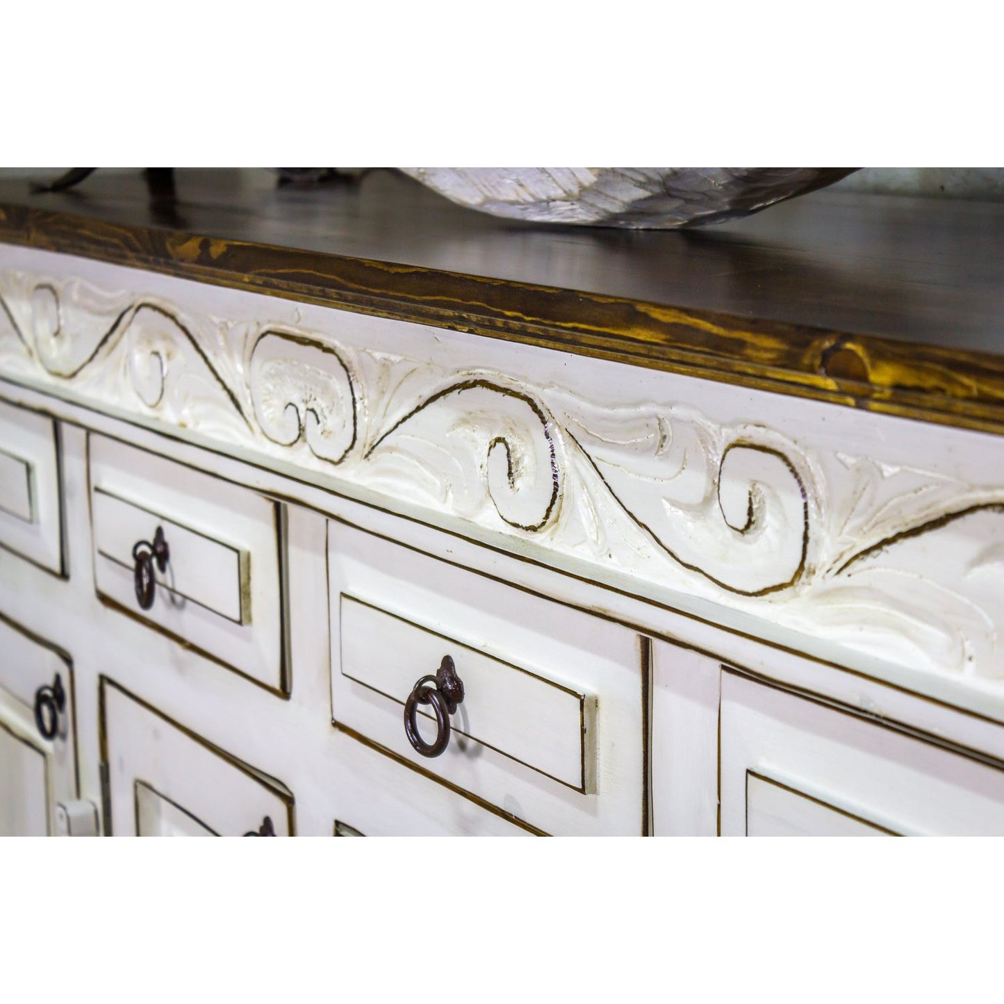 This Regency Buffet is crafted with hand-carved solid wood and features doors and drawers for ample storage. Finished in a distressed turquoise hue, it adds an elegant touch to any dining area.