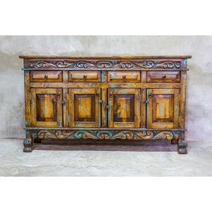 This Regency Buffet is crafted with hand-carved solid wood and features doors and drawers for ample storage. Finished in a distressed turquoise hue, it adds an elegant touch to any dining area.