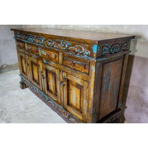 This Regency Buffet is crafted with hand-carved solid wood and features doors and drawers for ample storage. Finished in a distressed turquoise hue, it adds an elegant touch to any dining area.