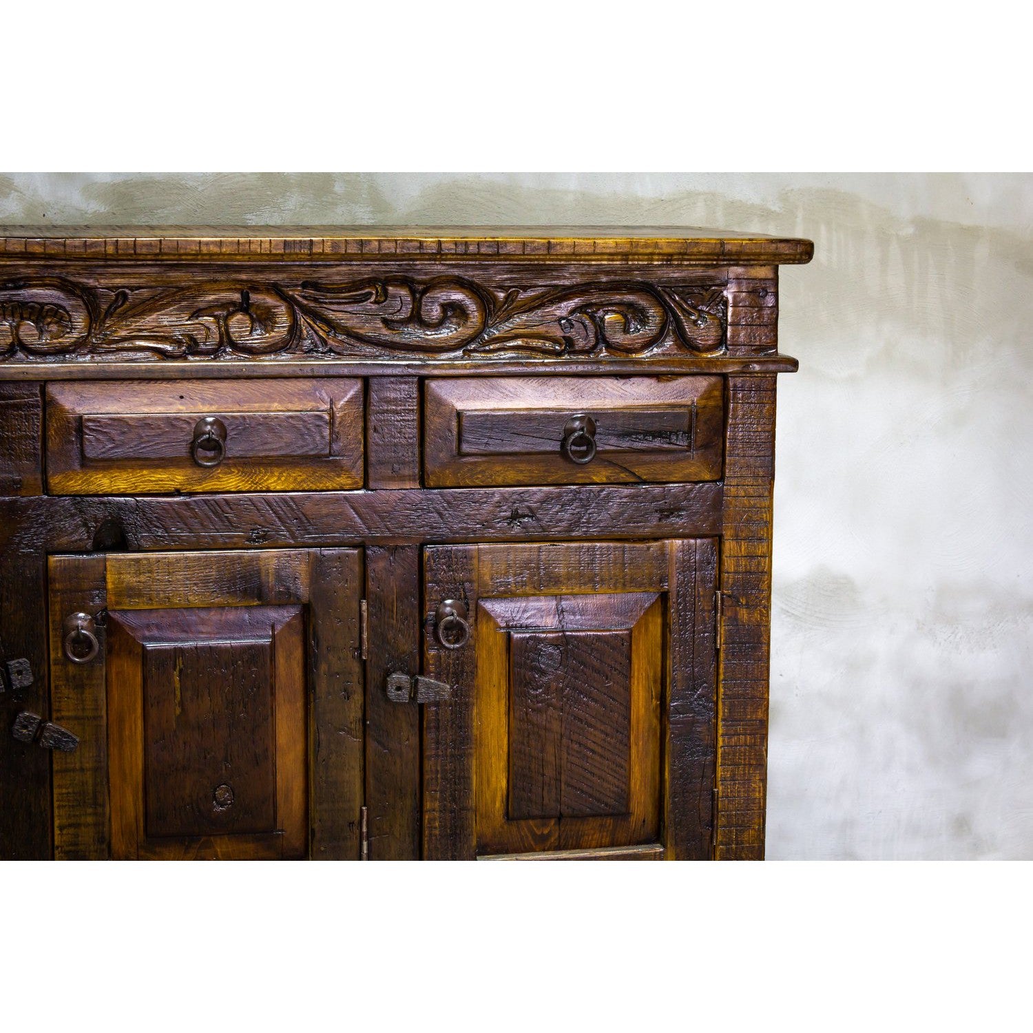 This Regency Buffet is crafted with hand-carved solid wood and features doors and drawers for ample storage. Finished in a distressed turquoise hue, it adds an elegant touch to any dining area.