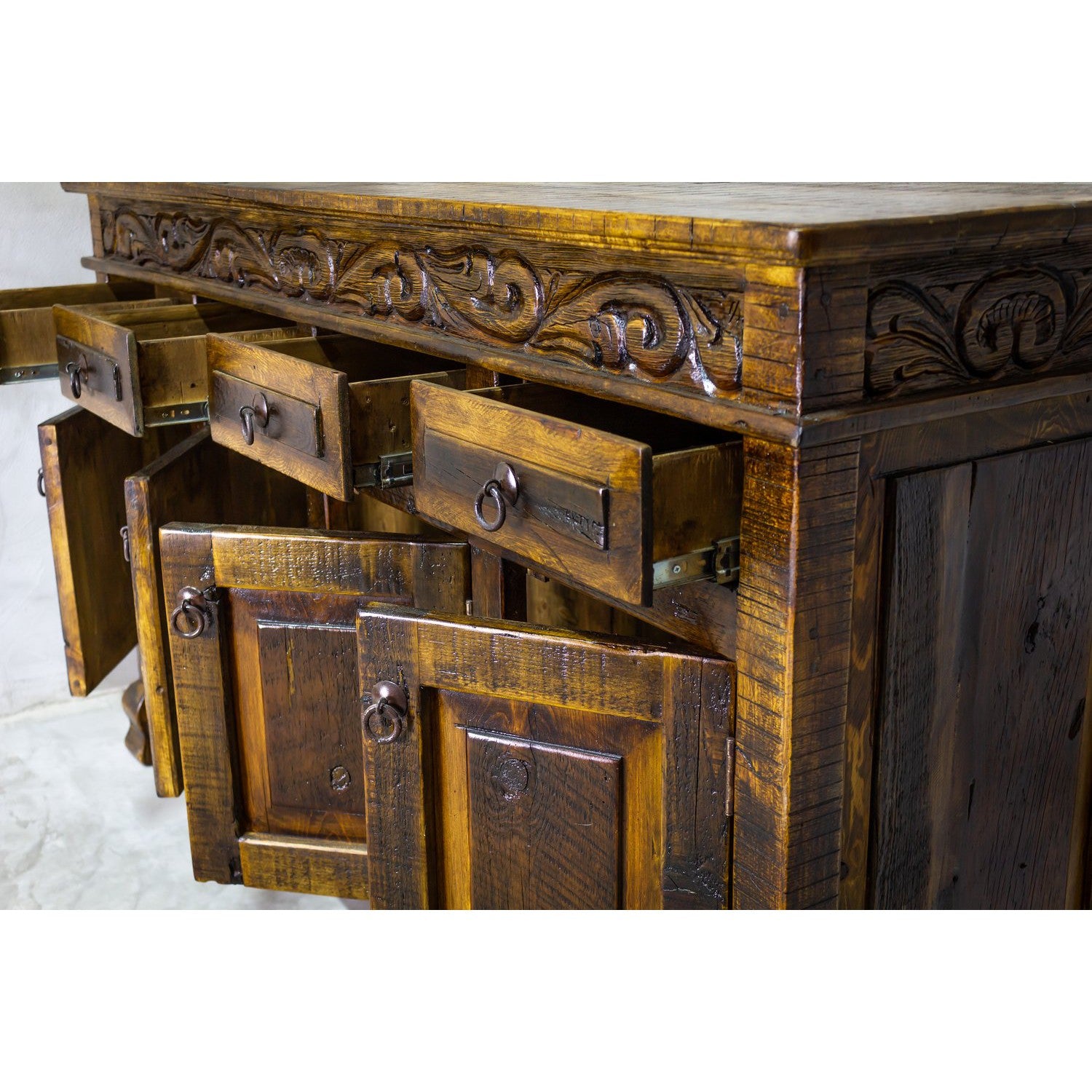 This Regency Buffet is crafted with hand-carved solid wood and features doors and drawers for ample storage. Finished in a distressed turquoise hue, it adds an elegant touch to any dining area.