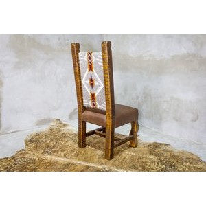 The Old Fashion Navajo Dining Chair adds rustic elegance to any home with its premium southwest upholstery and reclaimed wood construction. Enjoy its quality craftsmanship for a comfortable and unique seating experience.
