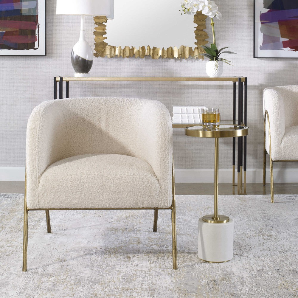 Introduce artful style to your home with the Jacobsen Accent Chair. Boasting an inspired Scandinavian design, the chair boasts an exquisite curved, aged gold finished iron frame and a luxurious off-white faux shearling seat, creating a timeless look to suit any living space. The perfect seat for curling up in, the chair is complete with a 19" seat height.