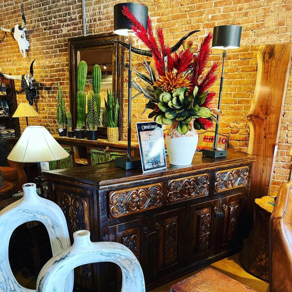 This beautiful hand-carved angled credenza is crafted from solid reclaimed wood, perfect for an entertainment stand or buffet. Its unique design adds a touch of elegance to any living space, and its sturdy construction ensures it can stand the test of time. Perfect for any home.