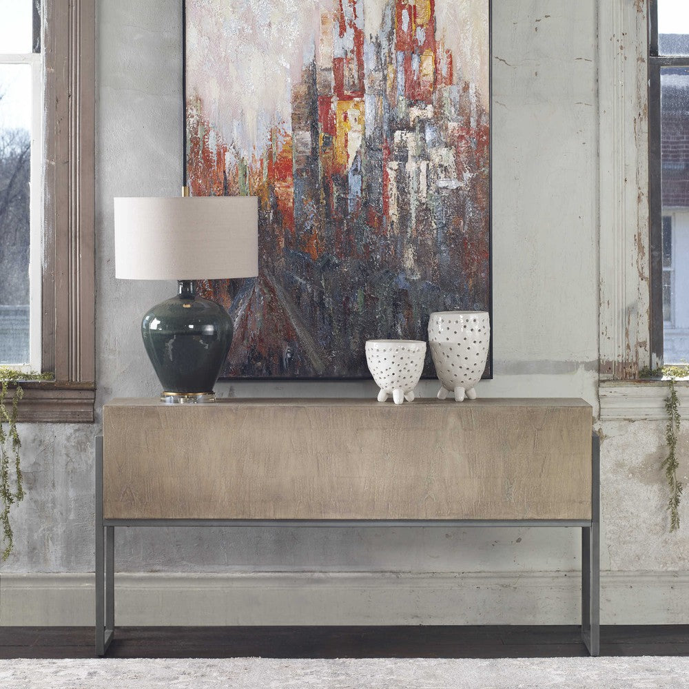 The Nevis Console is a beautiful contemporary piece, crafted from mahogany solids and mindi veneer in a hand-applied light oatmeal wash. The iron frame complements the layered veneer to create an attractive, unique grain pattern. Perfect for adding a touch of style to any interior.