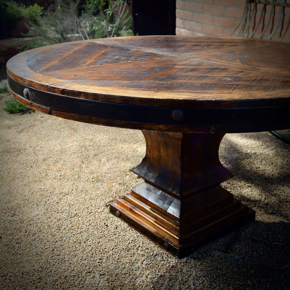 Add an unmistakable rustic elegance to your style with the Old Fashion Round Dining Table. Crafted from solid reclaimed wood and featuring a metal band with nailhead accents and a pedestal base, this handsome piece is designed to pair beautifully with any dining chairs. It's distressed finish complements its timeless, classic look.