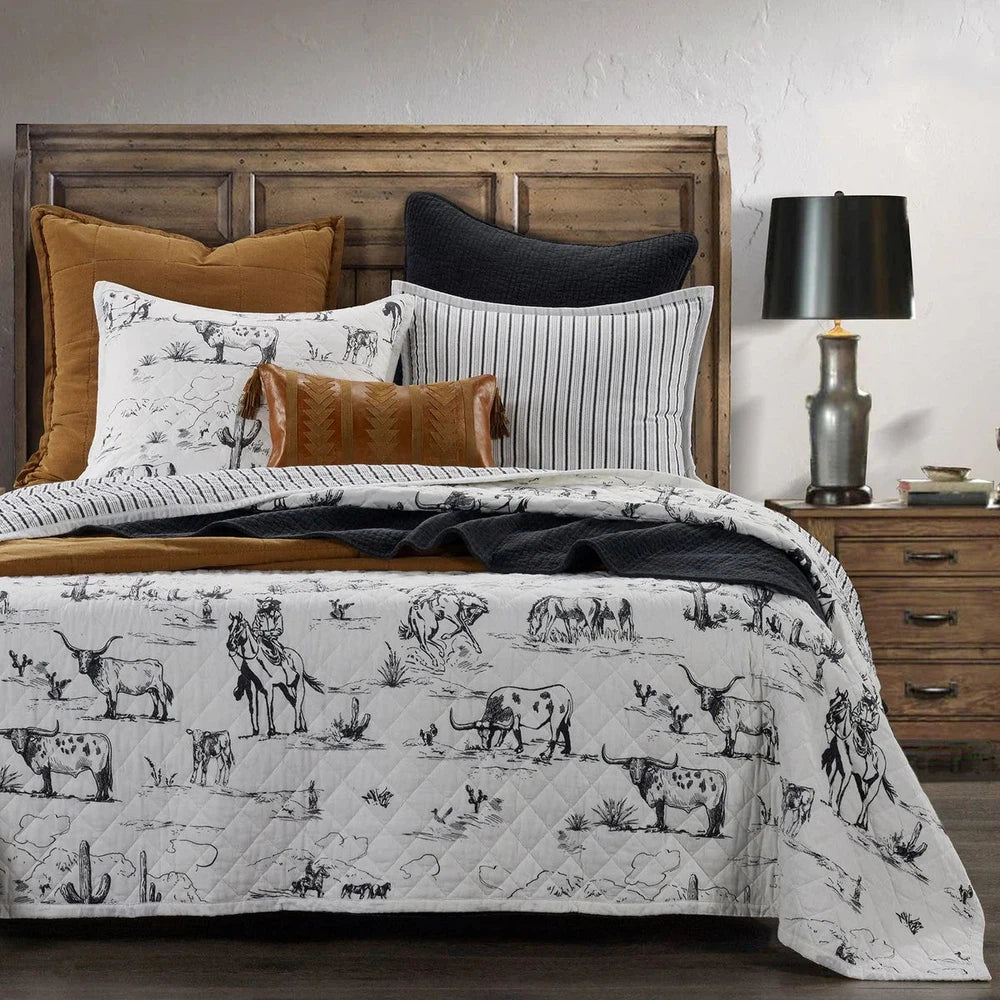Explore the wild West with our Ranch Life Western Toile Quilt Set. Reversible and perfect for modern and traditional Western interiors, the quilt features a classic black-and-white toile design with ticking stripes for a timeless look.