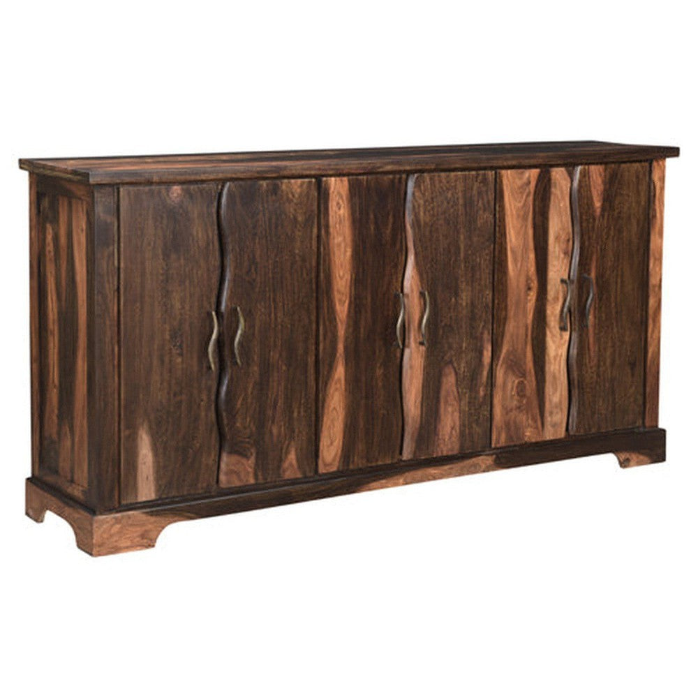 The Riviera Sideboard is an elegant piece of furniture with a refined dark finish. It features a live edge wood design and curved metal accents that add a modern touch. Perfect for stylishly stowing away your belongings, this sideboard is sure to elevate any living space.