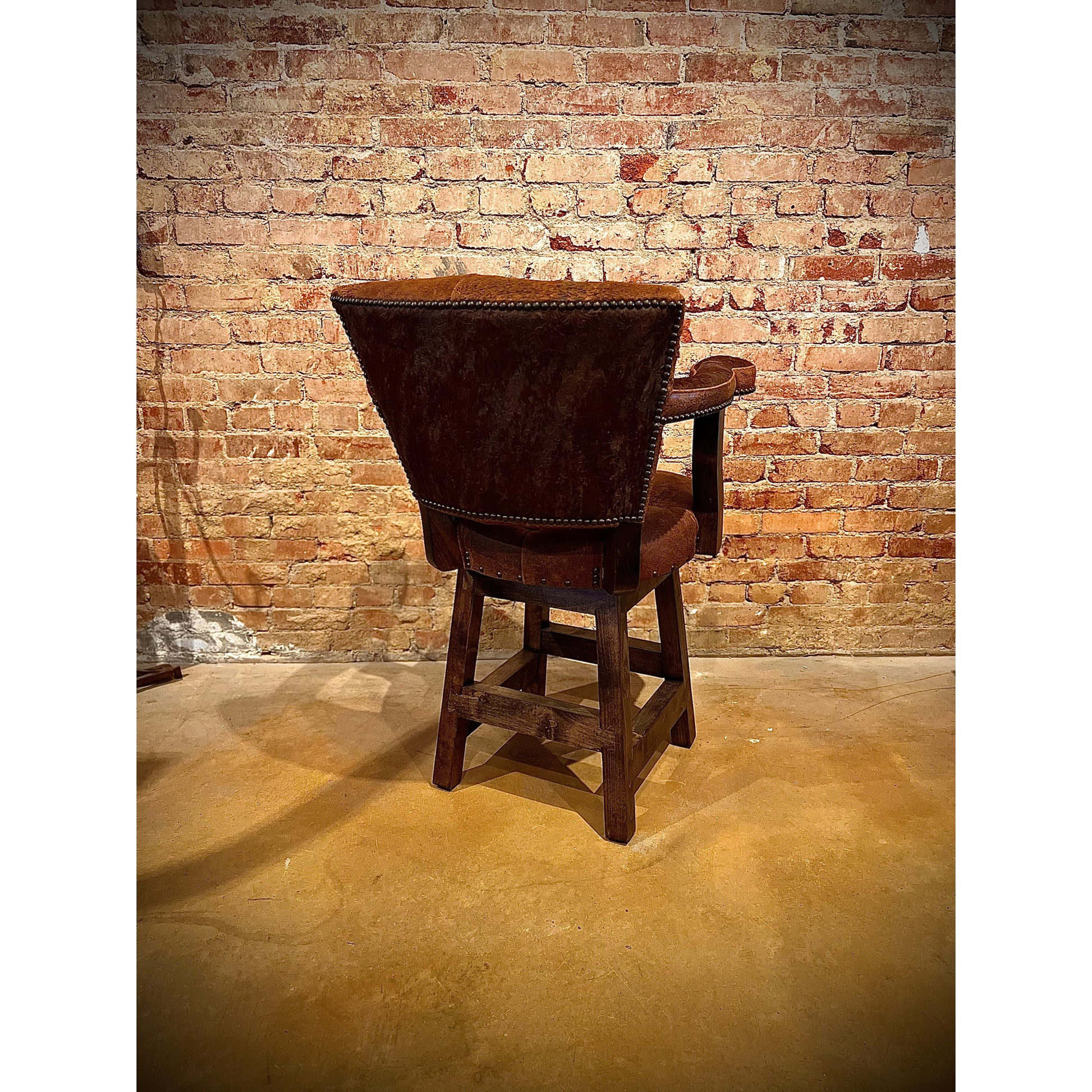 This Rough Out leather swivel barstool offers a comfortable and stylish seating option with its western design. Expertly crafted with high-quality leather, this barstool provides both durability and comfort. Perfect for any bar or kitchen counter, it adds a touch of rustic charm to any space.