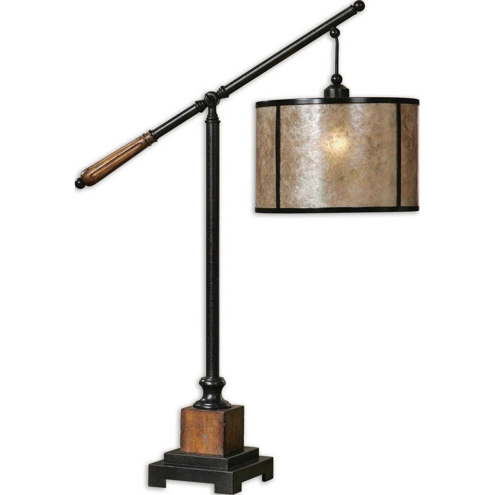 The Sitka Table Lamp features an aged black metal base accented with rustic mahogany and light rottenstone glaze solid wood details, plus a round drum shade of natural mica with aged black trim. This classic design is sure to lend a timeless look to any space.