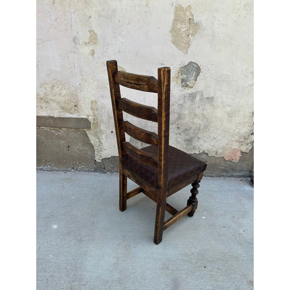 Elevate your dining room with the Sonora Dining Chair. This stylish chair is crafted of reclaimed wood, with a ladder back style for comfort and elegance, and a top grain diamond stamp leather seat for maximum comfort. Perfect for any dining room.