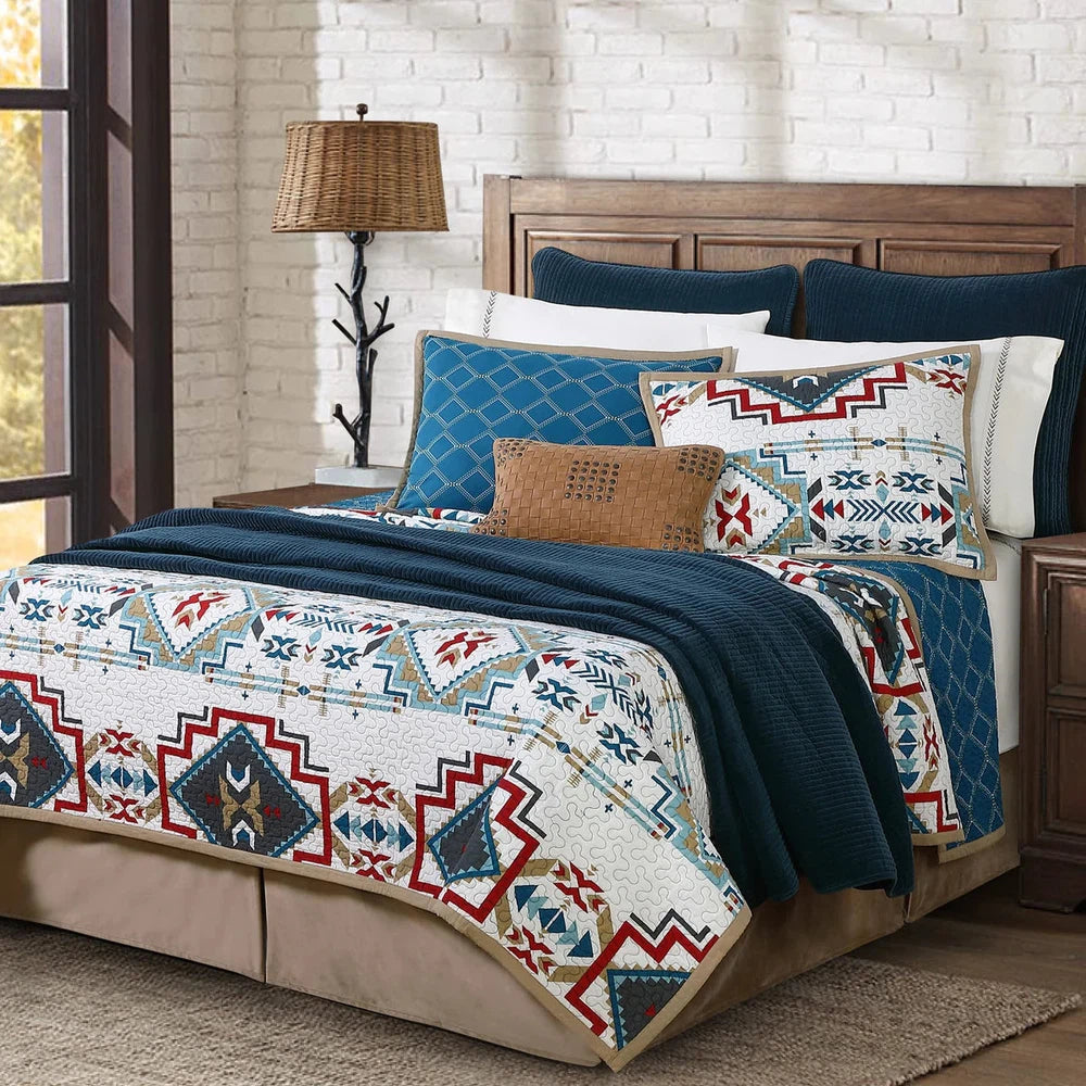 Bring a vibrant Southwestern touch to your bedroom with the Spirit Valley Quilt Set. Crafted in a palette of red, teal, taupe, and navy against a vintage white background, the Aztec-inspired pattern is reversible for an elegant and classic alternative. Enjoy the perfect balance of style and comfort.