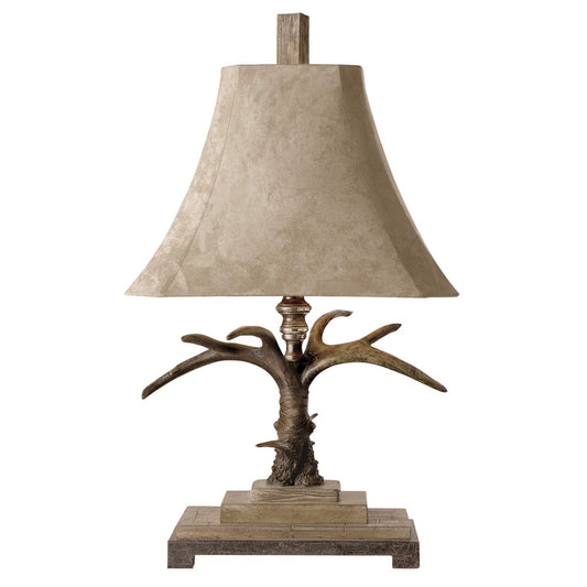 This Stag Horn Light Table Lamp is the perfect balance of modern and traditional aesthetics with its natural brown and ivory finish, scratched silver and cast aluminum accents, and a brushed palomino sueded shade with clipped corners. An ideal addition to any room.