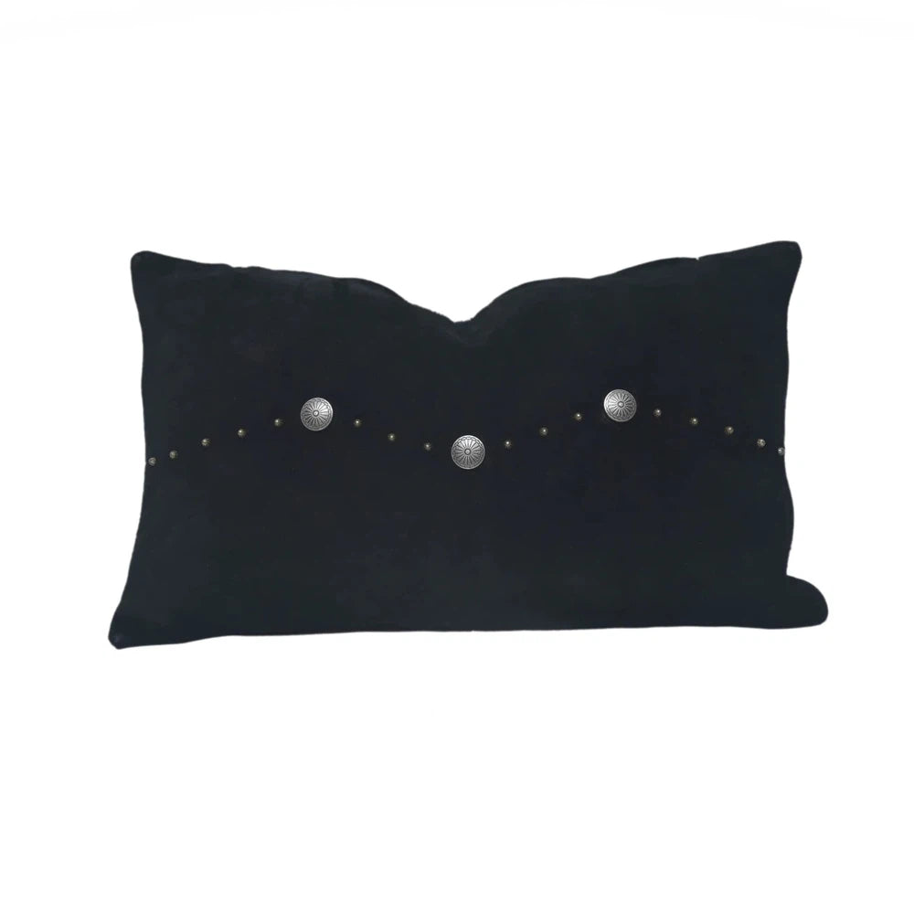 Classically crafted in suede, this Western Concho Pillow is perfect for any living space. Boasting a single silver concho center and a silver-studded border, its rustic elegance is available in four versatile shades: black, gray, navy, and tobacco. Add a luxurious touch to your the home with this timeless option.