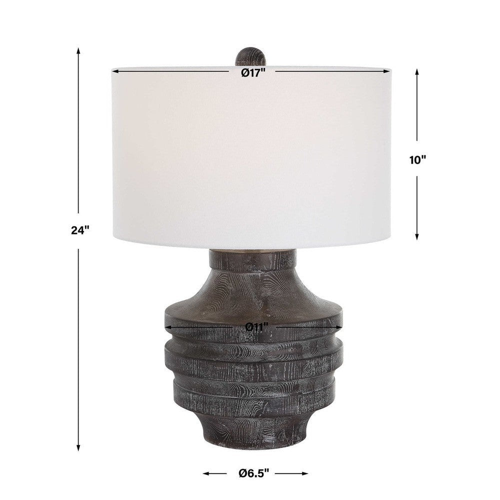 The perfect rustic accent, the Timber Table Lamp brings the outdoors in with a carved wood look in a transparent black stain with warm undertones and a light white glaze accentuating the faux wood grain. The hardback drum shade is covered in a white cotton fabric.