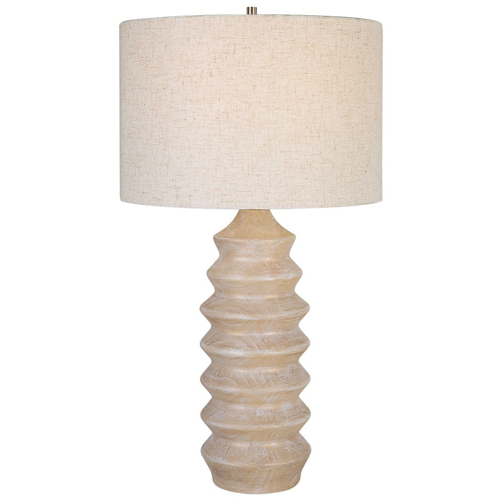 Make a bright statement in your home with the Uplift Table Lamp. It features a carved geometric base in a bleached wood tone look with nickel plated iron details. This modern lamp is finished with a casual oatmeal linen slubbed drum shade, creating a stunning aesthetic