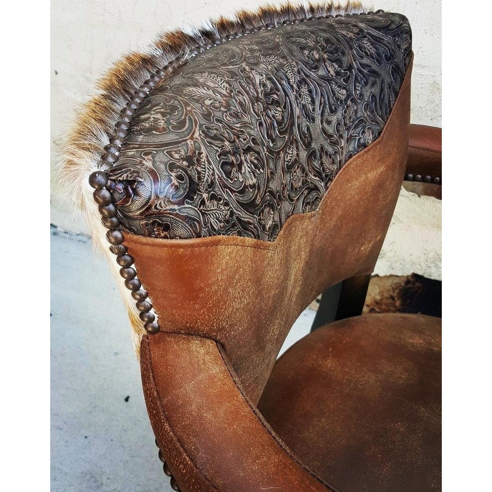 Bring the rustic appeal of the Wild West to your home with the Uptown Cowboy Swivel Stool. Crafted with top grain leather and axis hair on hide, this swivel bar or counter stool also features a stamped leather yoke, and comes in arm or armless options so you can customize it for your space.