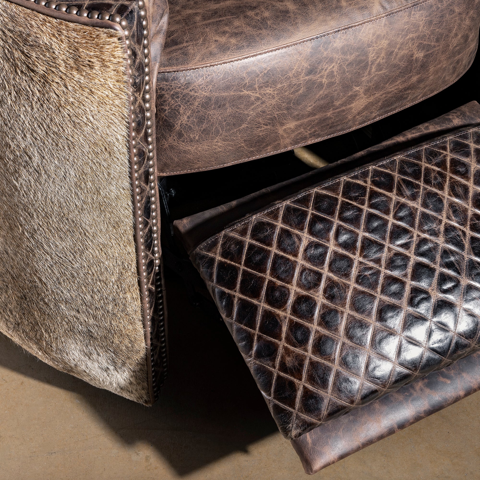 Diamond embossed leather footrest close-up on Bitterroot Hide Cuddler Recliner, luxury Western reclining chair detail
