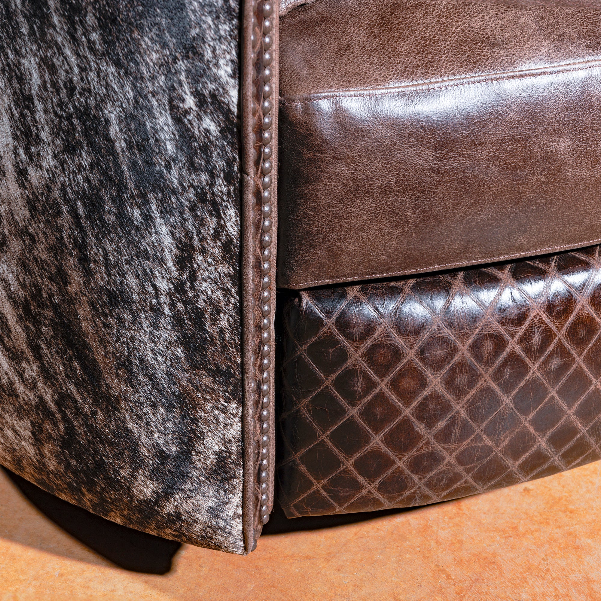 Close-up of top-grain leather and antique nailhead detailing on Western recliner