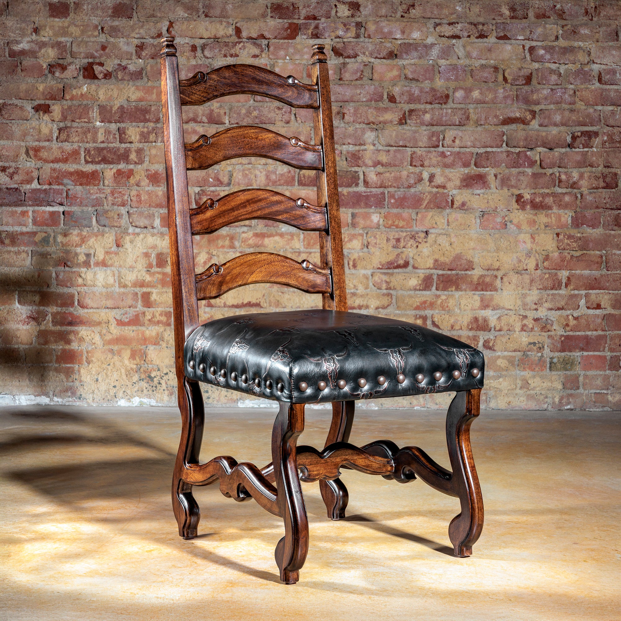 Ladderback Western dining chair with embossed black leather seat and hand-carved wood frame