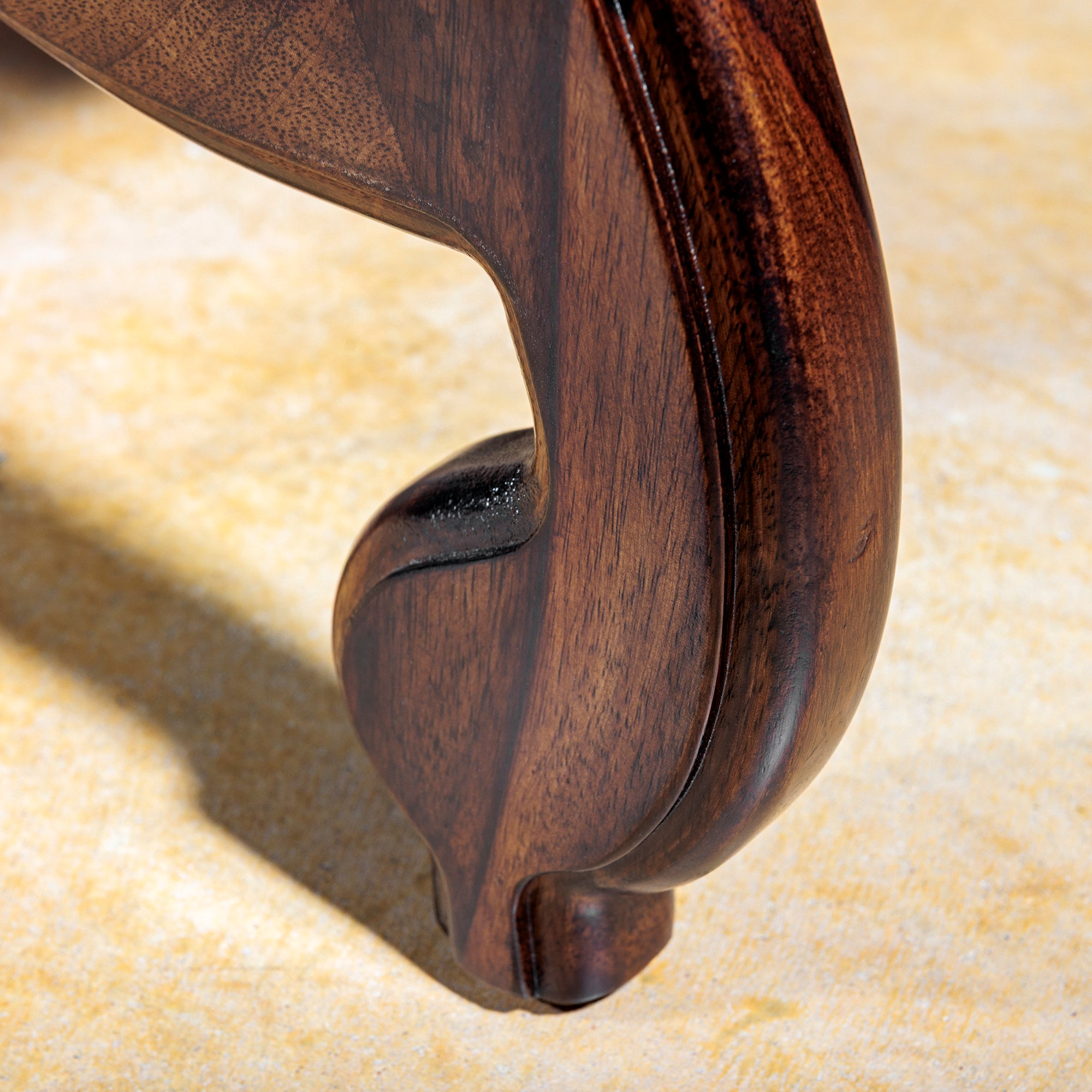 Ornate carved wood leg of the Western dining chair