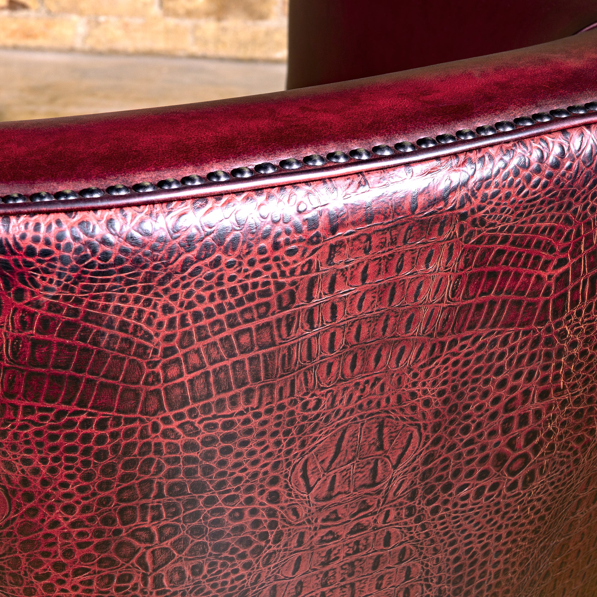 Bordeaux Croc Chair western swivel chair with deep red leather seat, curved arms, bronze nailheads, and swivel base