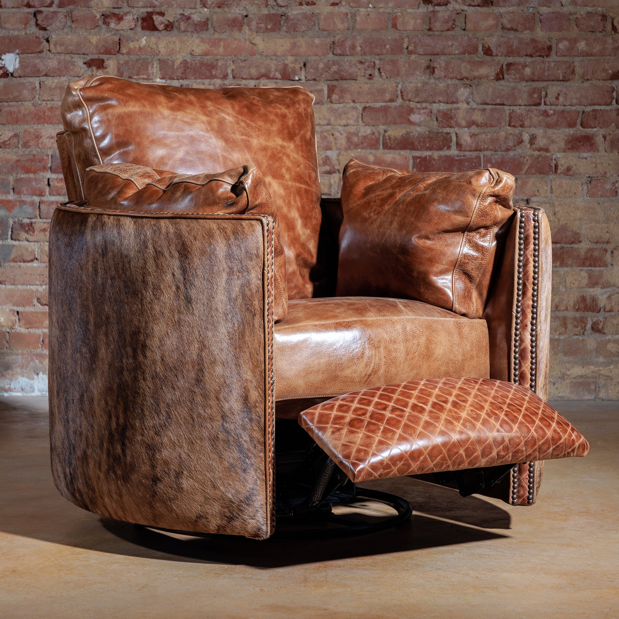 Side view of oversized leather and cowhide swivel recliner with nailhead accents