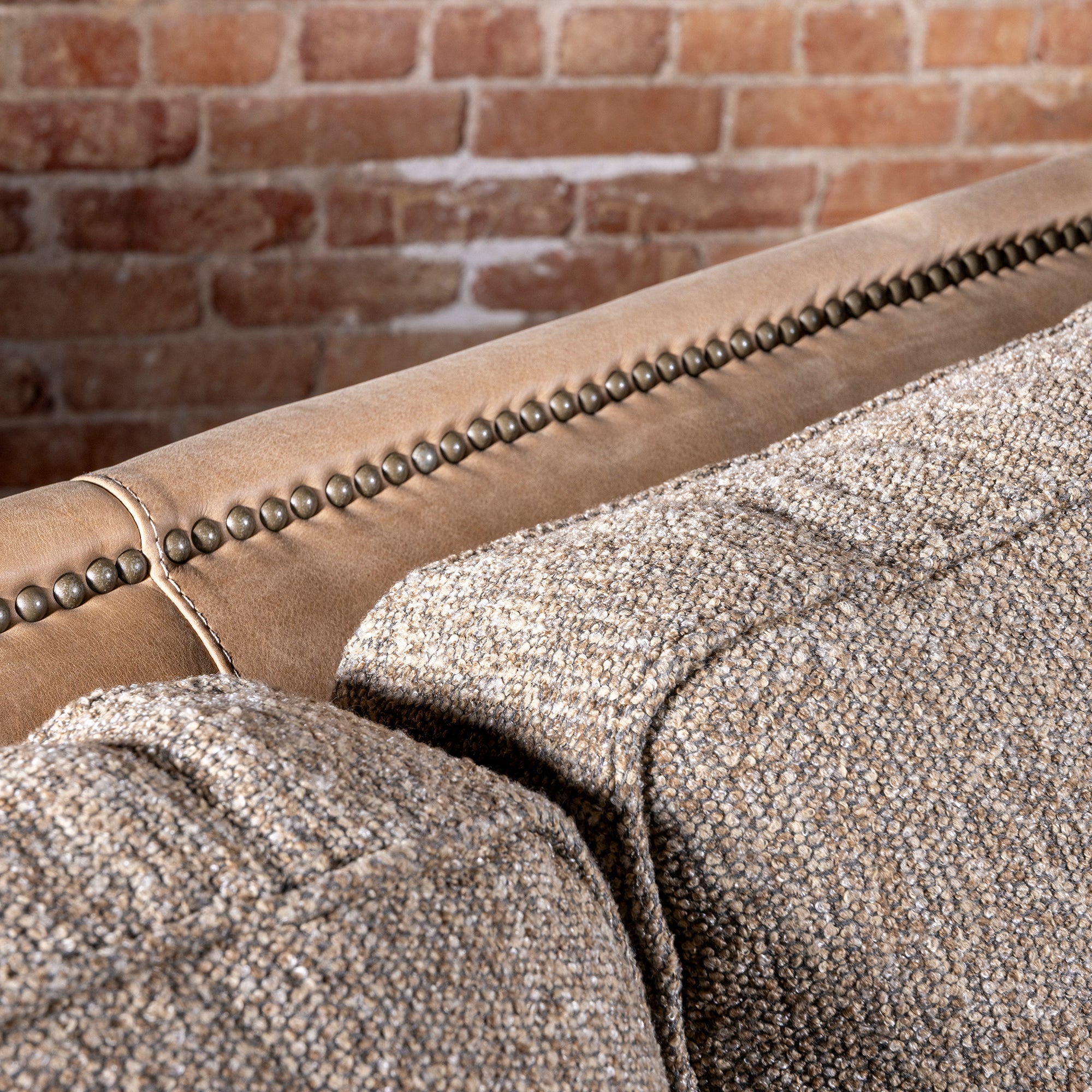 Bridger Nailhead Sofa western sofa with tan leather back, antique nailhead trim, and textured woven cushions