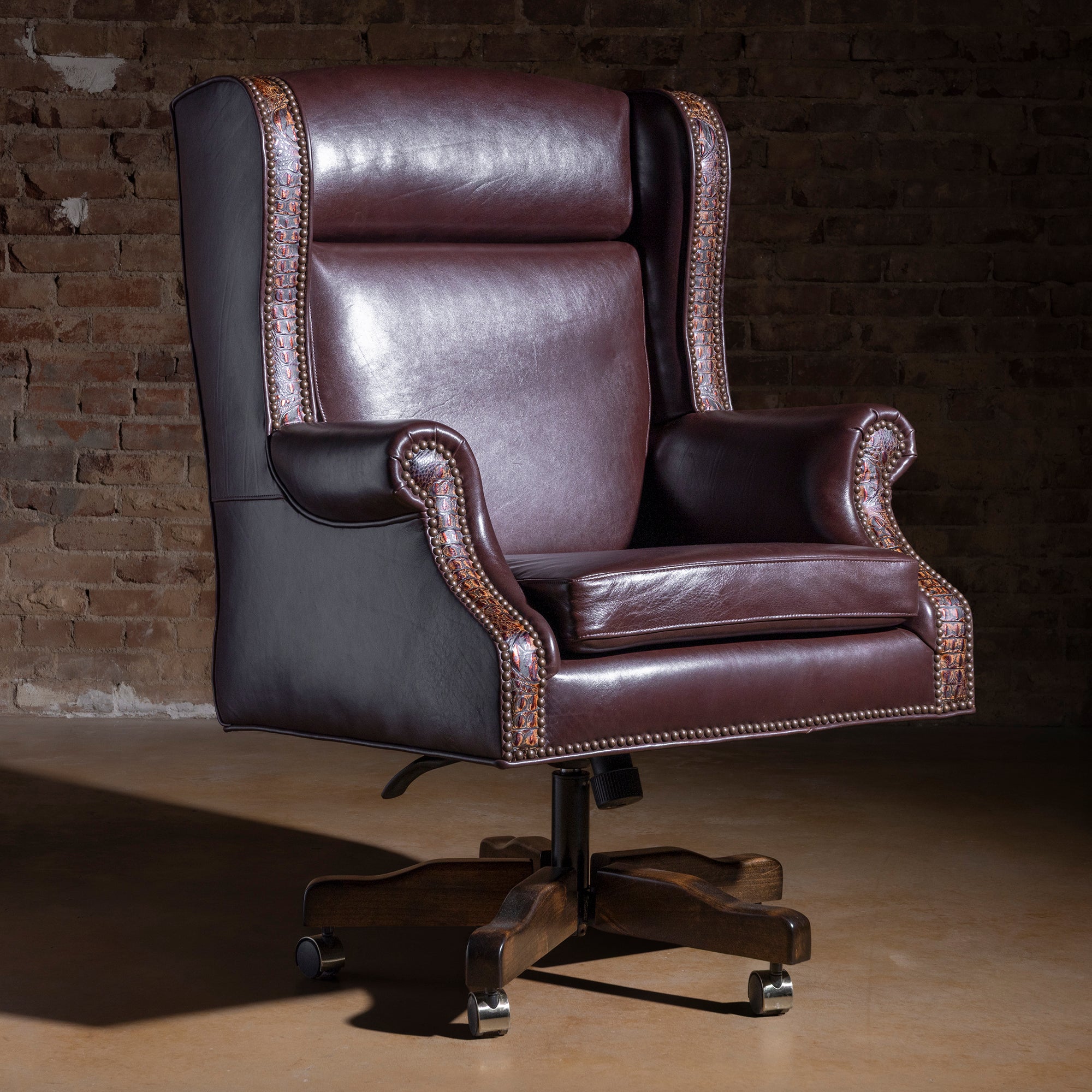 Leather desk chair with tooled leather accents, nailhead trim, and swivel caster base